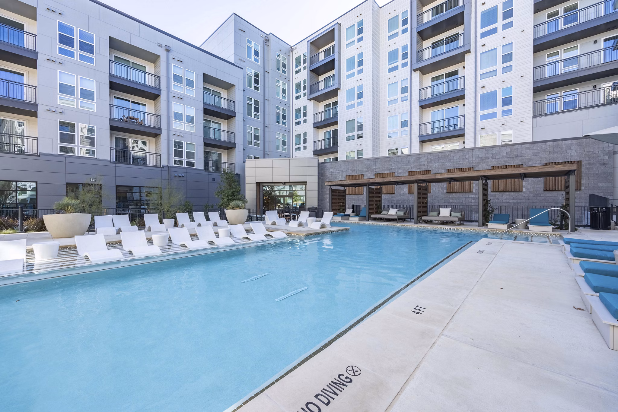 Modern outdoor pool area at Alder Apartments offering luxury amenities for relaxation and recreation