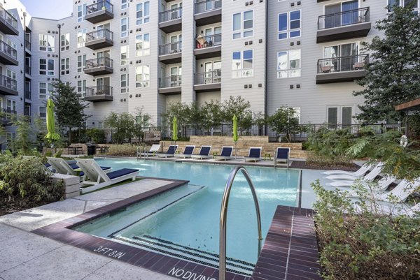 Resort-style pool with lounge chairs at Alder Apartments