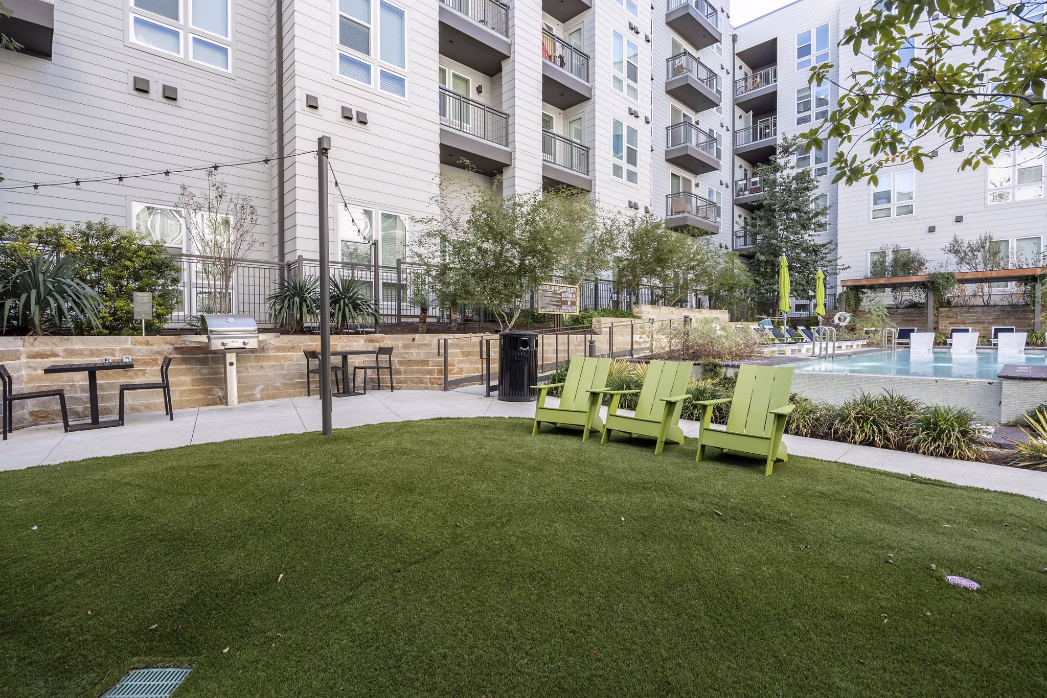 Alder Apartments: Serene courtyard featuring lush gardens and seating areas for community relaxation