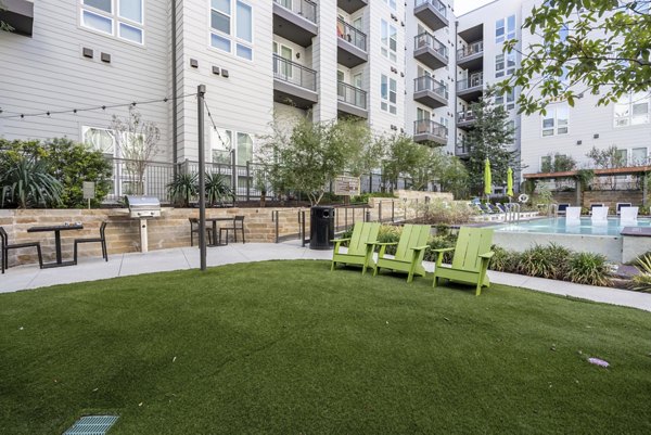 Alder Apartments: Serene courtyard featuring lush gardens and seating areas for community relaxation