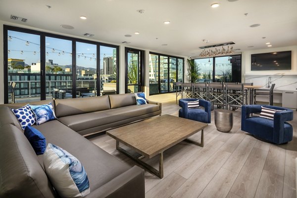 Clubhouse featuring modern design and ample seating at Rise Hollywood Apartments