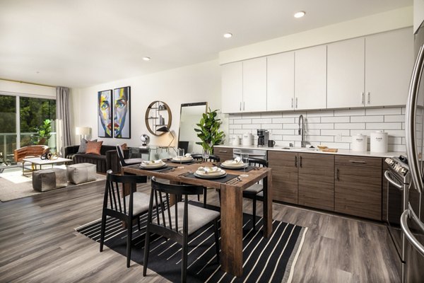 Modern dining area with sleek furniture in Rise Hollywood Apartments, featuring open layout perfect for entertaining in luxury urban setting