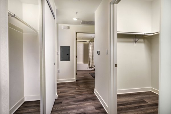 Elegant hallway with modern lighting and artwork at Rise Hollywood Apartments