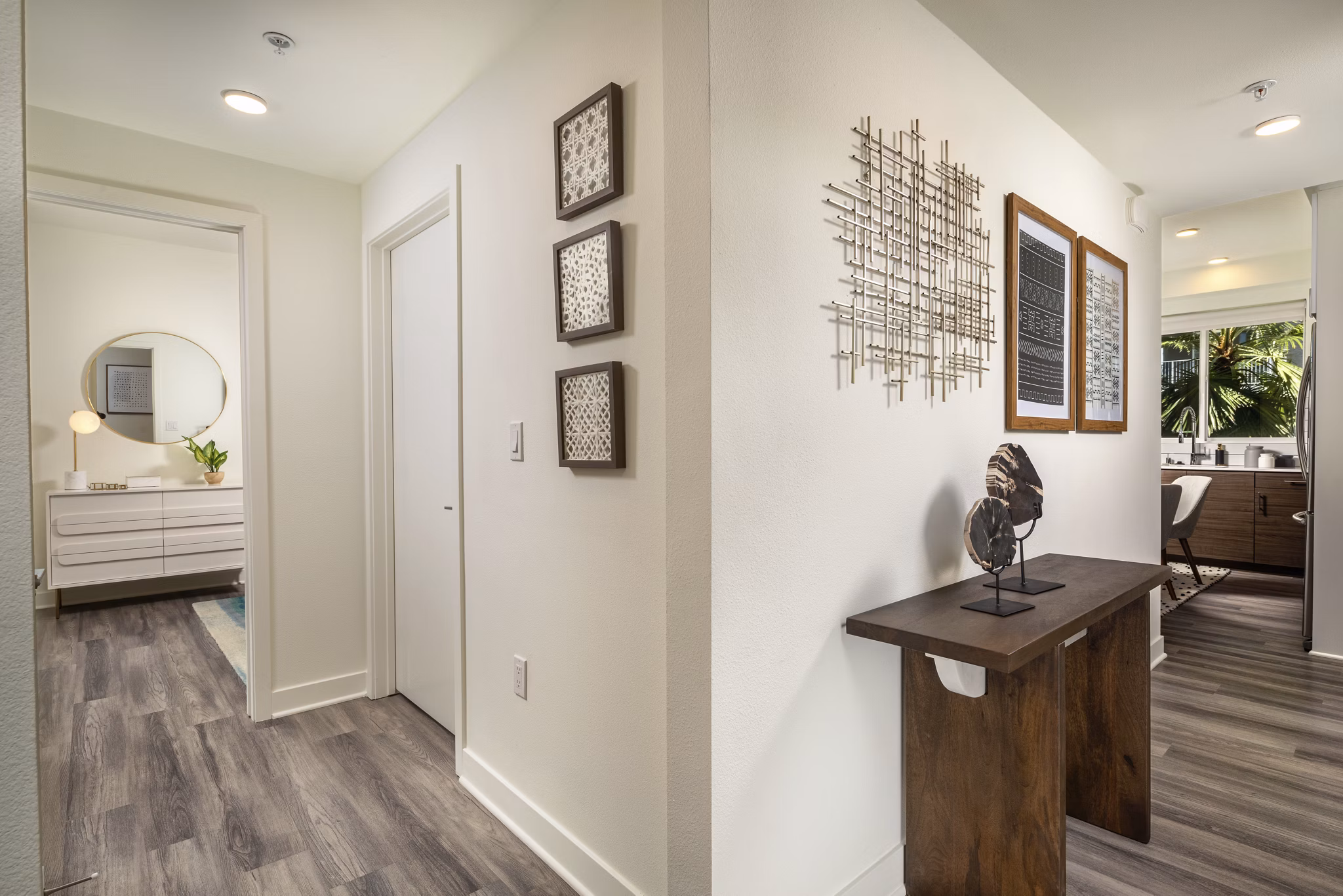 Hallway featuring modern lighting and art at Rise Hollywood Apartments