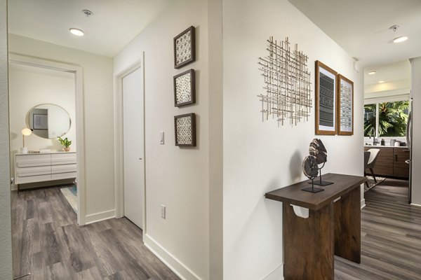 Hallway featuring modern lighting and art at Rise Hollywood Apartments