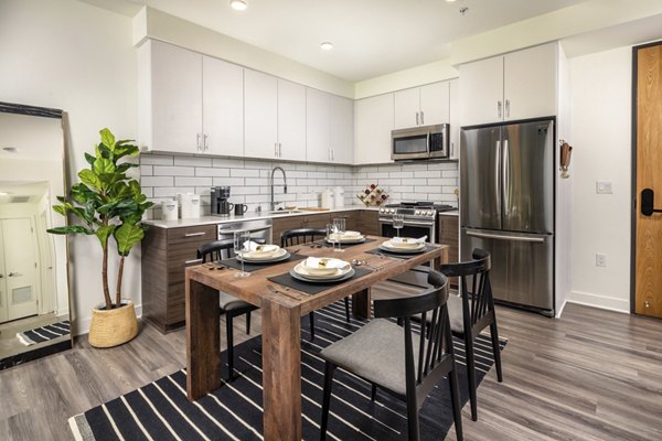 Modern kitchen with stainless steel appliances at Rise Hollywood Apartments