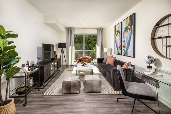Spacious living room with modern decor at Rise Hollywood Apartments featuring luxury amenities and vibrant city views