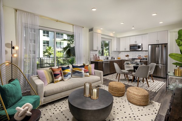 Contemporary living room with stylish decor and large windows at Rise Hollywood Apartments