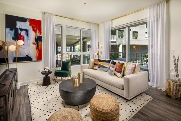 Spacious living room with modern decor and open layout at Rise Hollywood Apartments