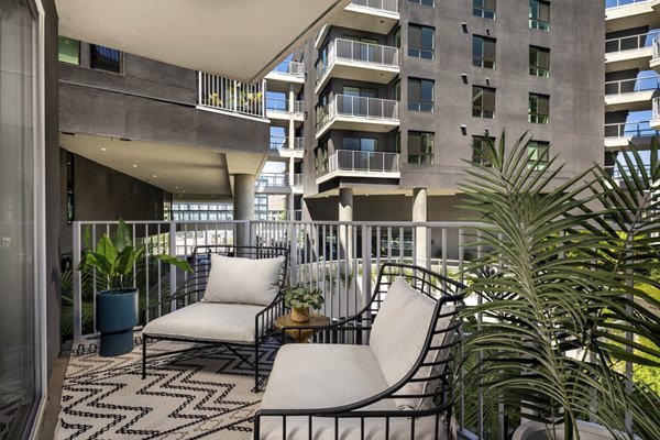 Patio with modern seating and green views at Rise Hollywood Apartments, offering luxury outdoor living spaces in the heart of Los Angeles