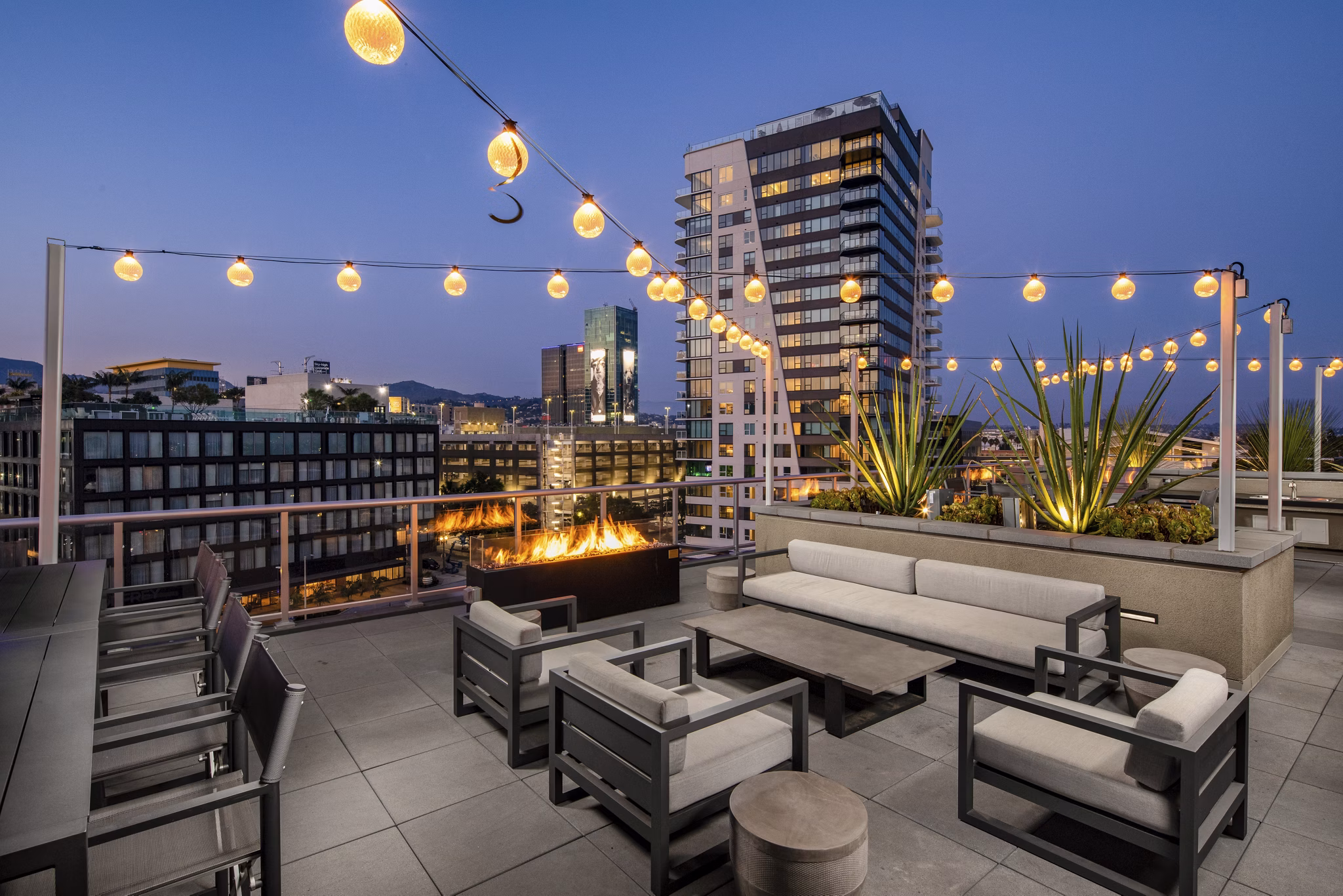 Rooftop deck with modern seating and city views at Rise Hollywood Apartments