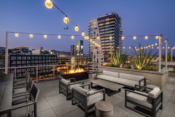 Rooftop deck with modern seating and city views at Rise Hollywood Apartments