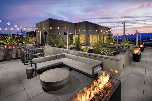 Cozy fire pit gathering area at Rise Hollywood Apartments featuring comfortable seating and ambient lighting