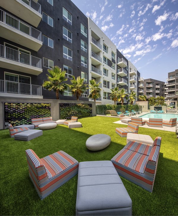 Rise Hollywood Apartments: Tranquil courtyard with lush greenery and seating areas in central Los Angeles