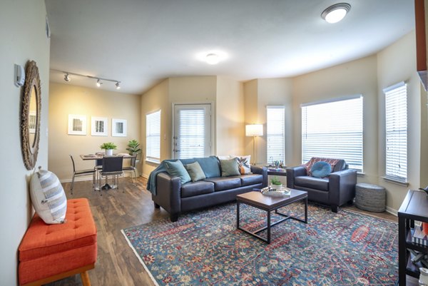 Spacious living room with contemporary decor in Hillside Ranch Apartments, featuring stylish furniture and natural lighting