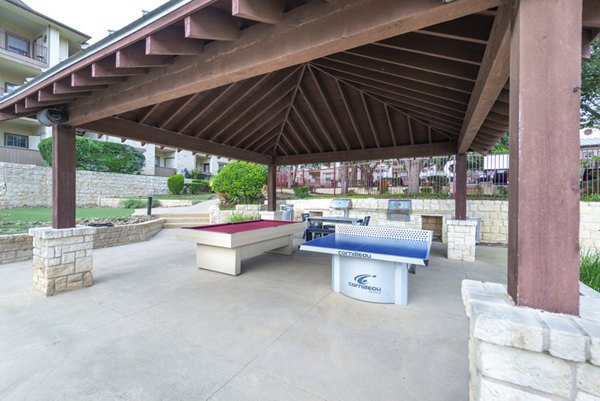 Outdoor grill area with seating at Hillside Ranch Apartments, ideal for gatherings and BBQs