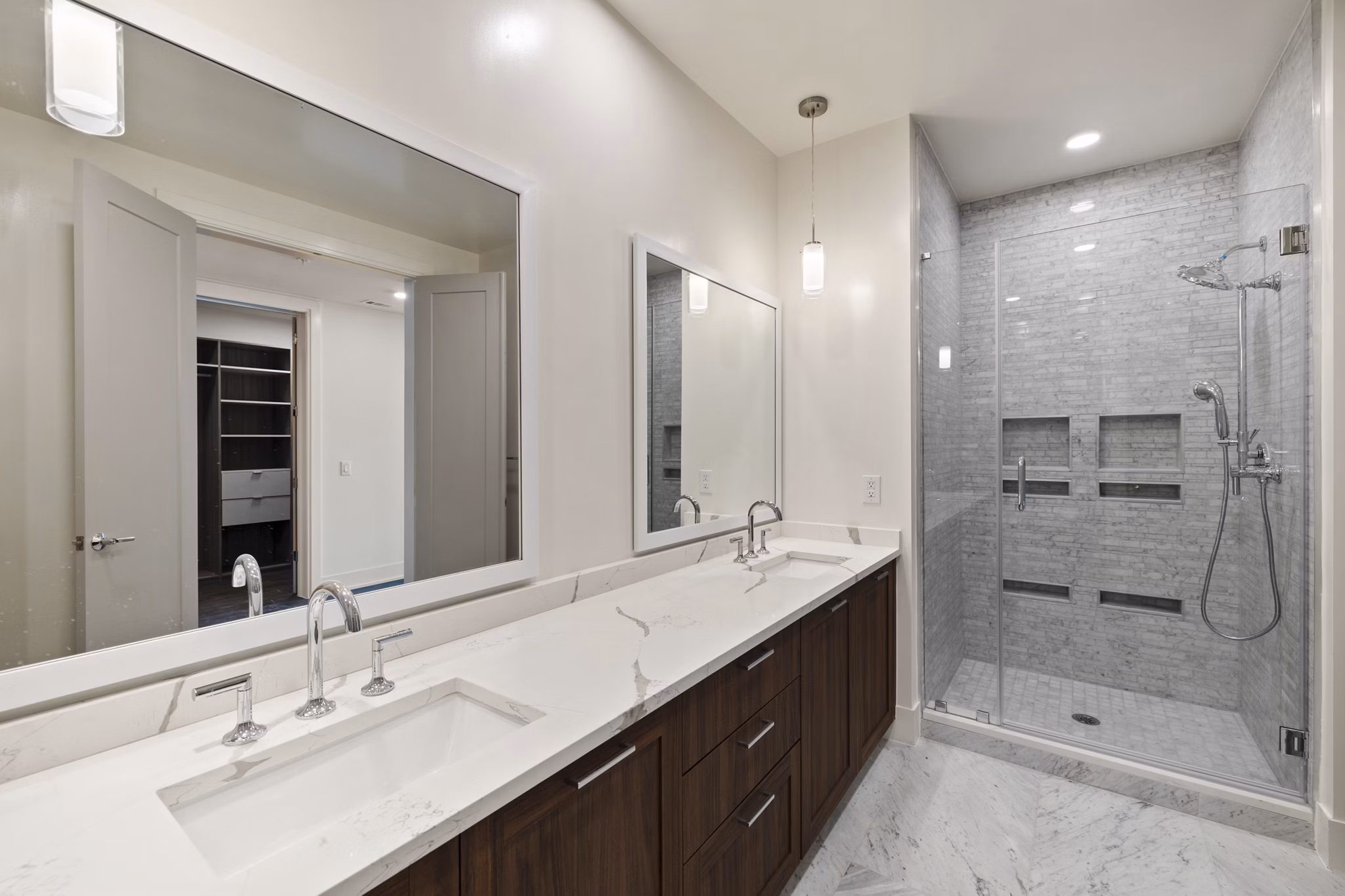 Bathroom with sleek fixtures and marble countertop at The Westcott Apartments