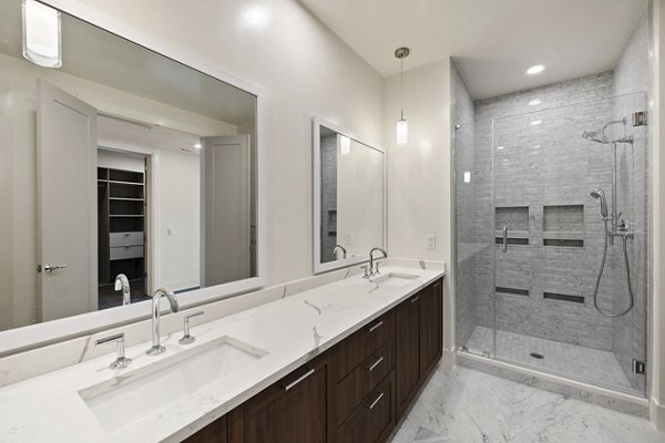Bathroom with sleek fixtures and marble countertop at The Westcott Apartments
