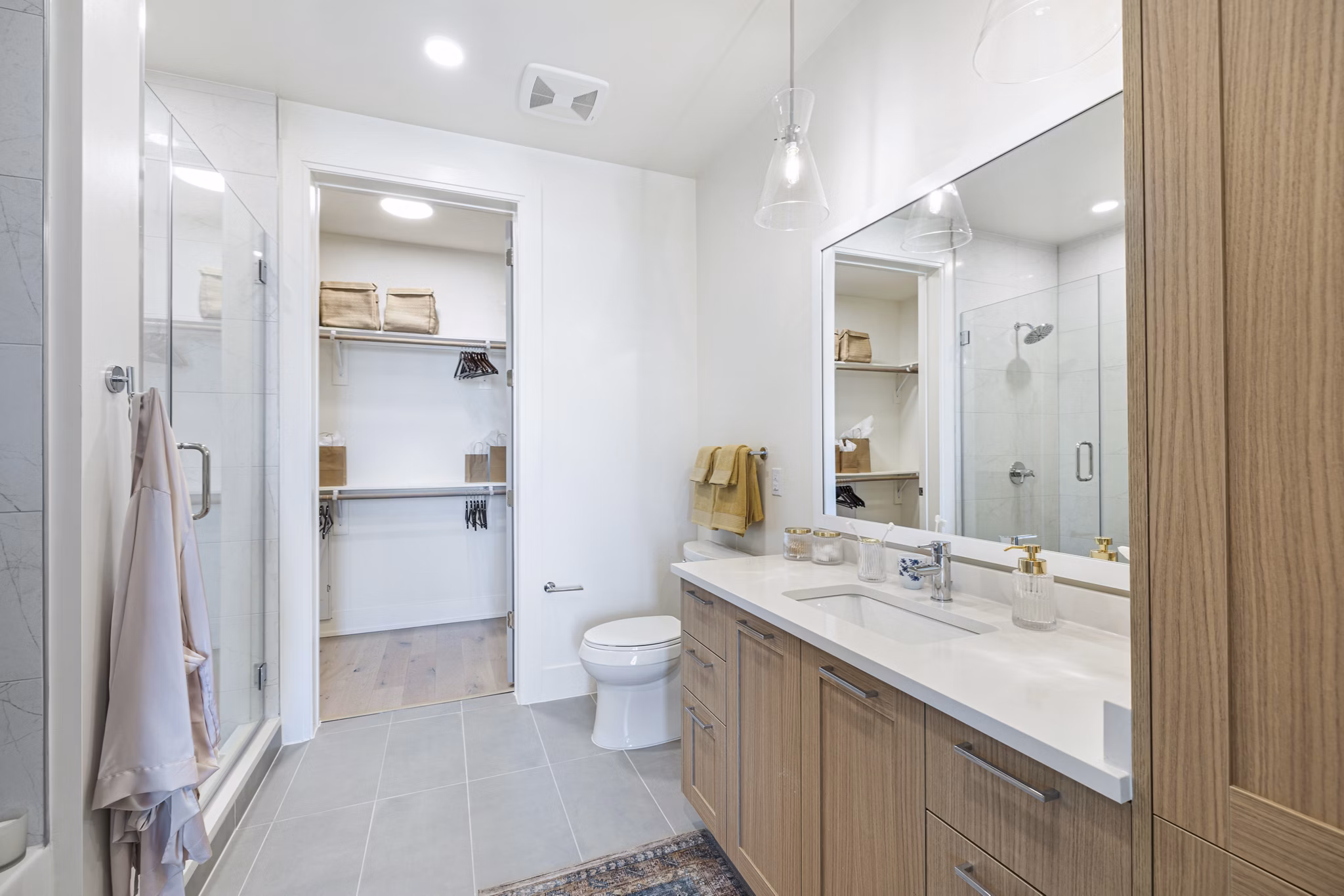 Bathroom featuring marble countertops and modern fixtures in The Westcott Apartments