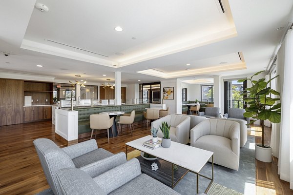 Clubhouse with modern furnishings and spacious seating areas at The Westcott Apartments, ideal for social gatherings and relaxation