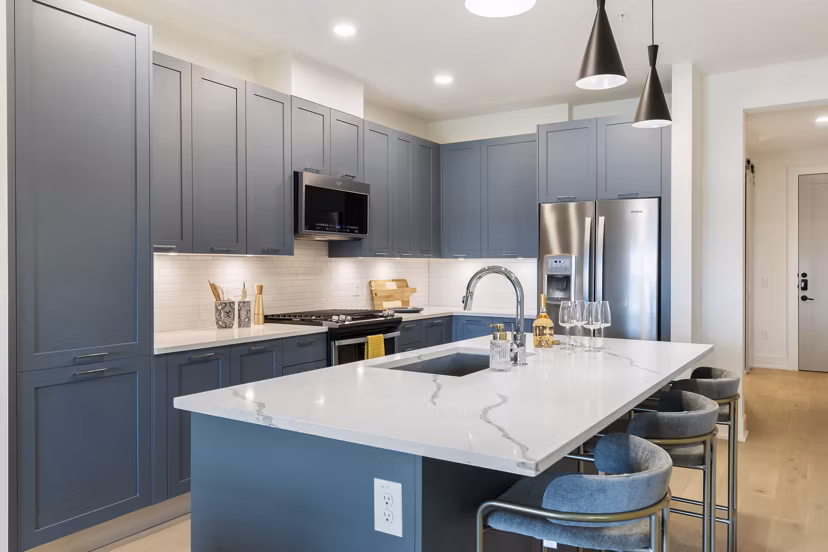 Kitchen with sleek countertops and modern appliances in The Westcott Apartments, luxury living in a Greystar community