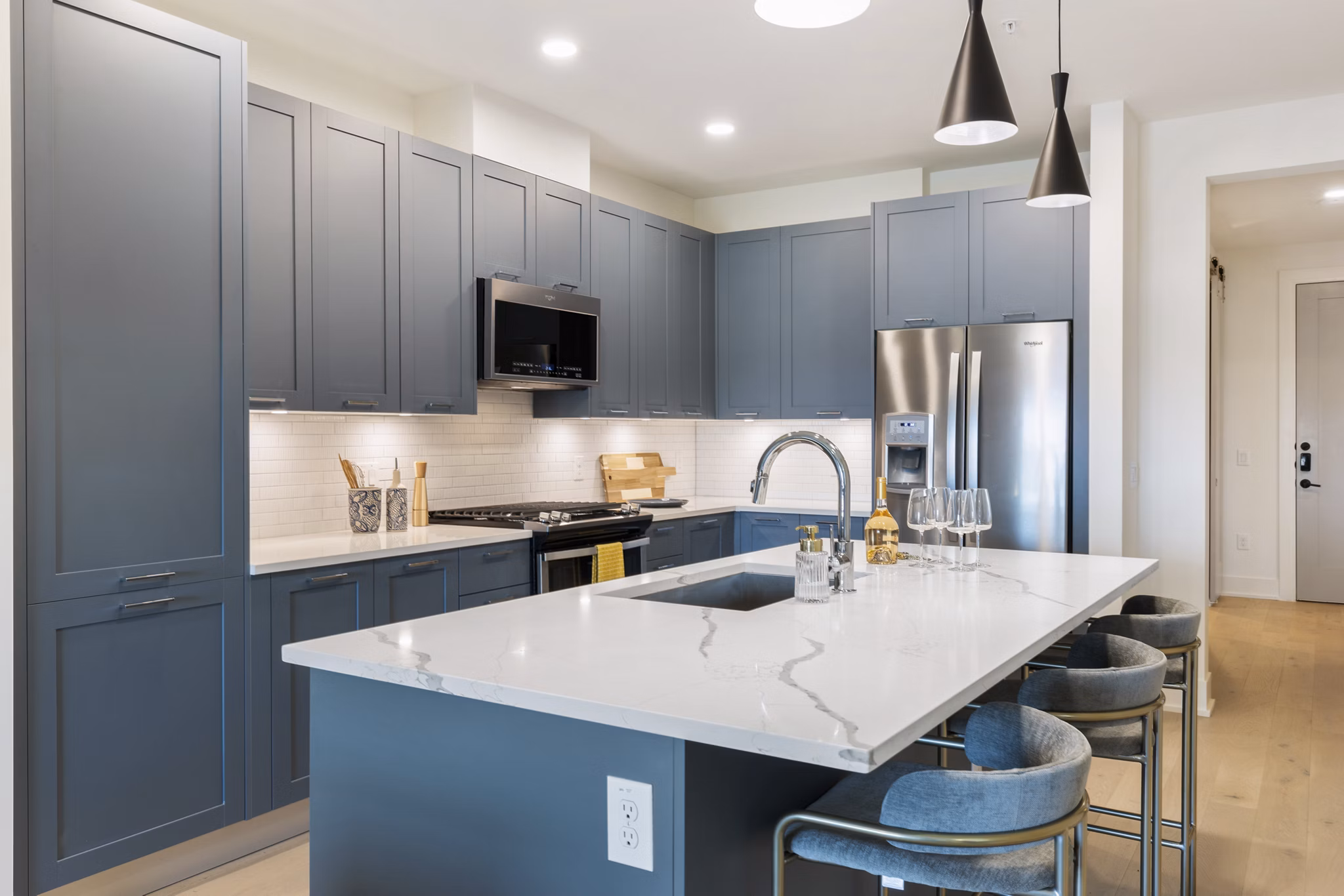 Kitchen with sleek countertops and modern appliances in The Westcott Apartments, luxury living in a Greystar community