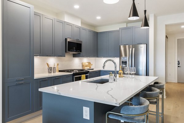 Kitchen with sleek countertops and modern appliances in The Westcott Apartments, luxury living in a Greystar community