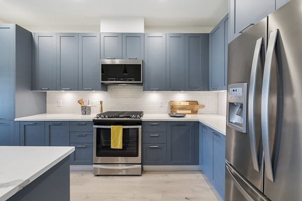 Modern kitchen with stainless steel appliances and sleek cabinetry at The Westcott Apartments, a luxury property by Greystar