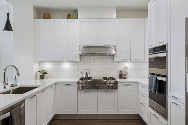 Modern kitchen with sleek cabinetry and stainless steel appliances in The Westcott Apartments