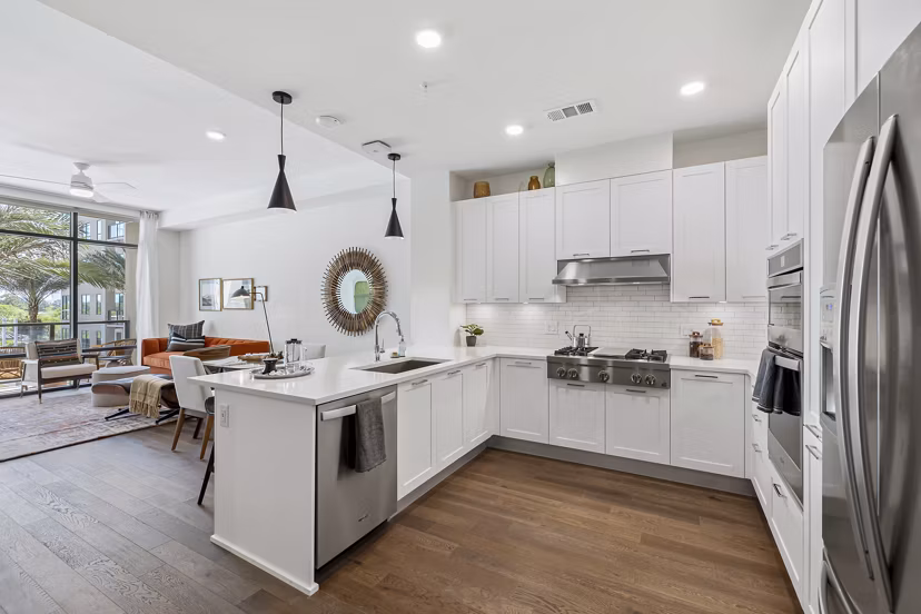 Modern kitchen with stainless steel appliances in The Westcott Apartments