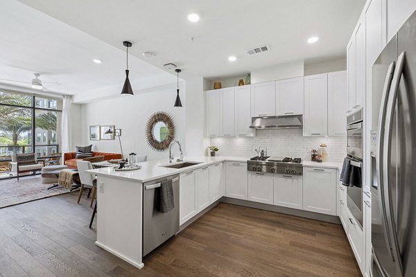Modern kitchen with stainless steel appliances in The Westcott Apartments