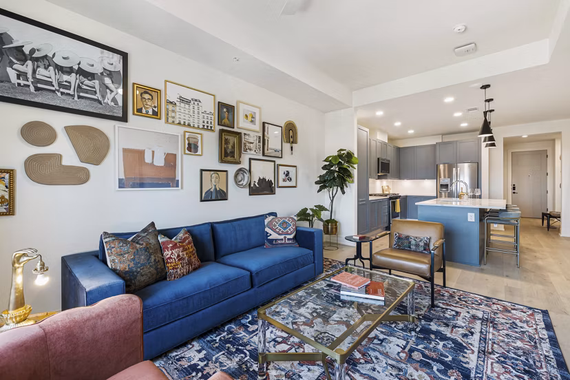Contemporary living room with large windows and modern decor at The Westcott Apartments