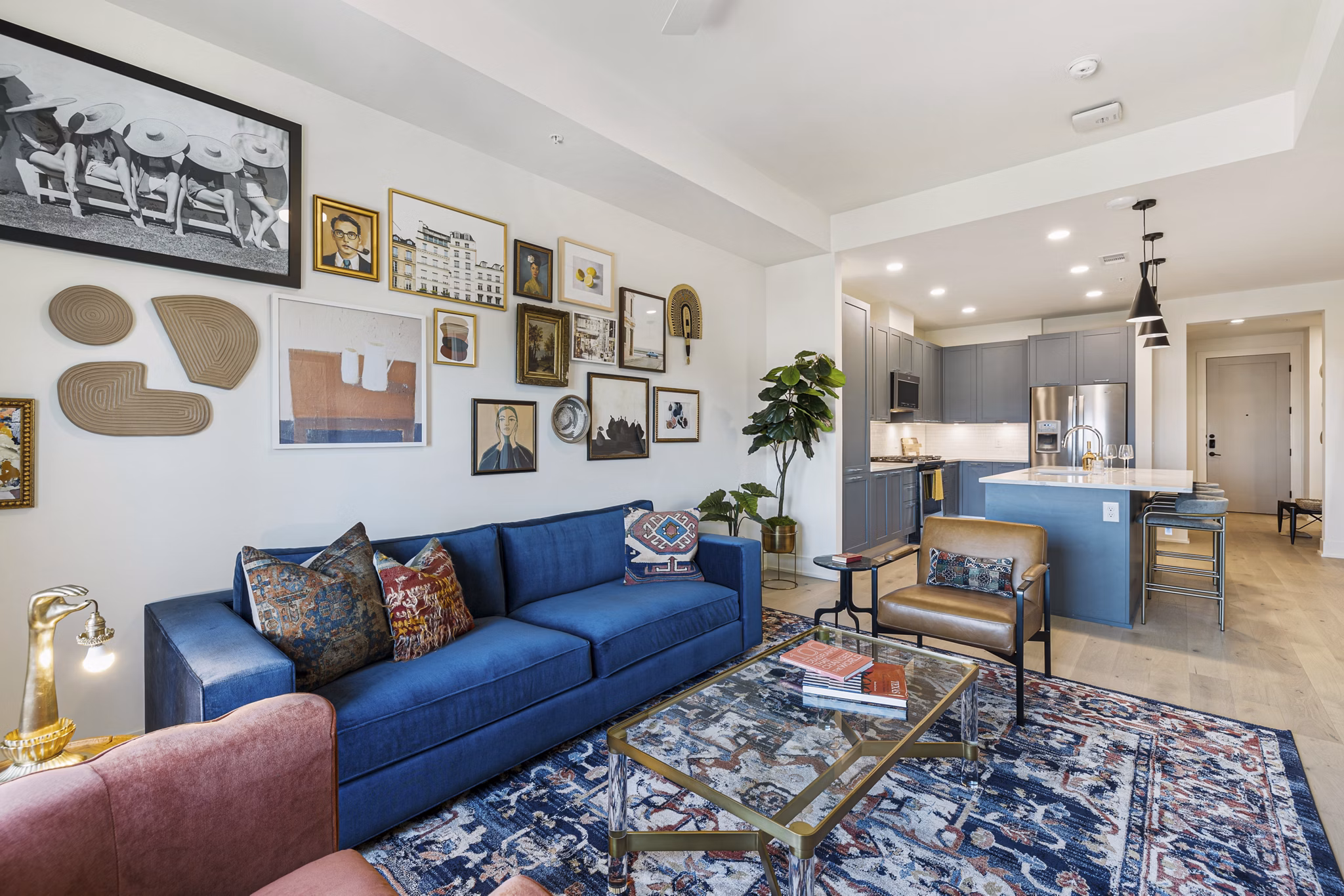 Contemporary living room with large windows and modern decor at The Westcott Apartments
