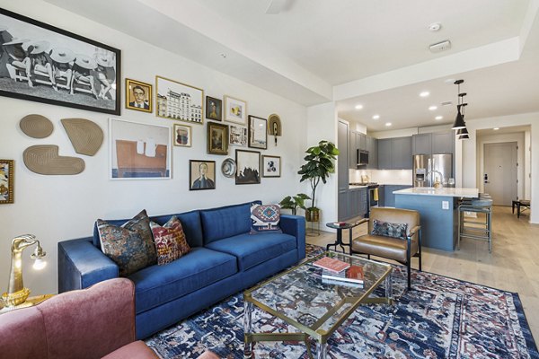 Contemporary living room with large windows and modern decor at The Westcott Apartments