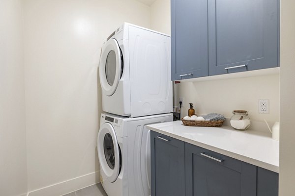 Laundry room featuring modern appliances at The Westcott Apartments