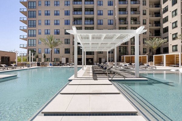 Resort-style pool with lounging areas at The Westcott Apartments, luxury living in a vibrant community setting