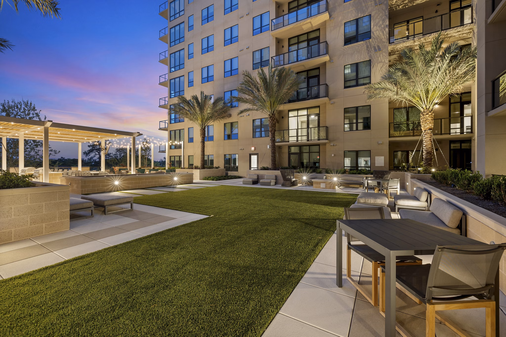 The Westcott Apartments: Serene courtyard featuring lush landscaping and cozy seating areas