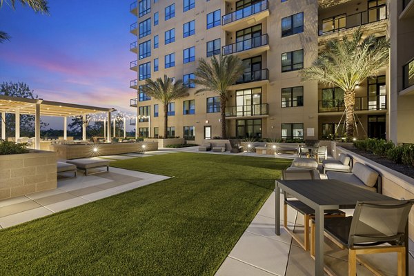 The Westcott Apartments: Serene courtyard featuring lush landscaping and cozy seating areas