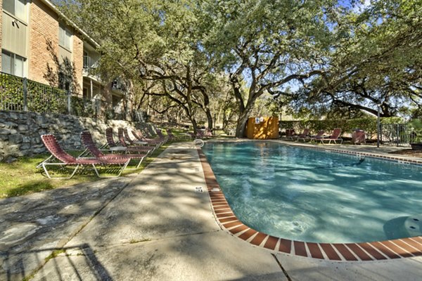 Sunlit pool area at Treehouse Apartments with lounge chairs - perfect for relaxation and luxury living