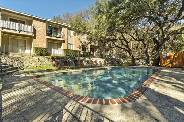 Modern pool area with surrounding loungers at Treehouse Apartments