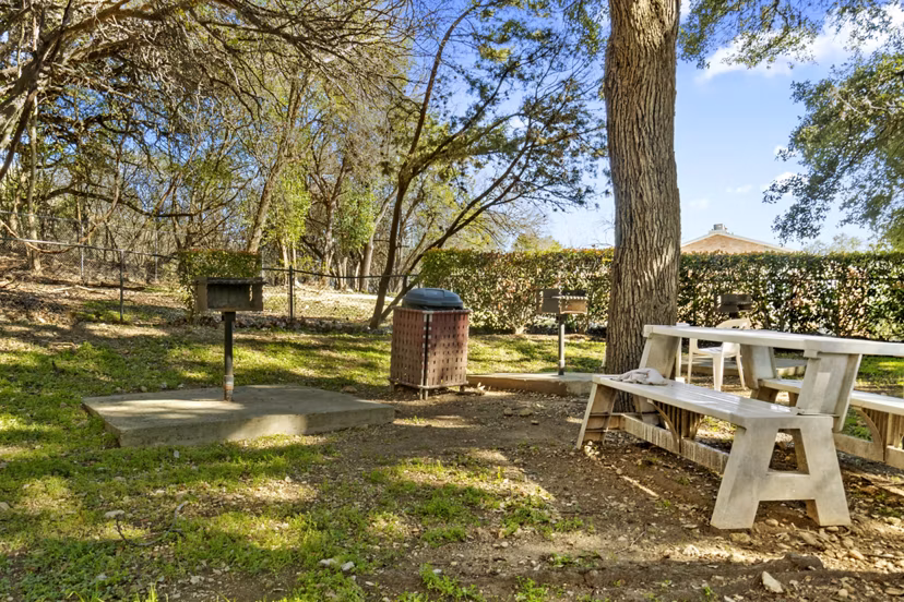 Outdoor grill area with modern seating at Treehouse Apartments, a luxury community offering premium amenities for entertaining and relaxation