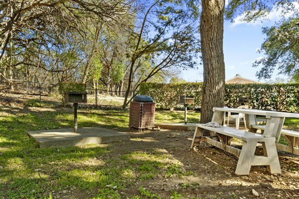 Outdoor grill area with modern seating at Treehouse Apartments, a luxury community offering premium amenities for entertaining and relaxation