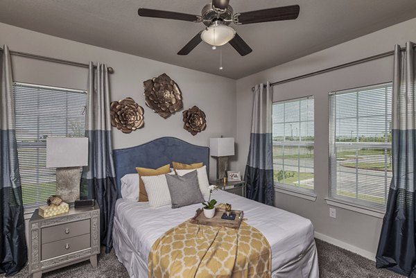 Cozy bedroom featuring modern decor at Roots at Waco Apartments