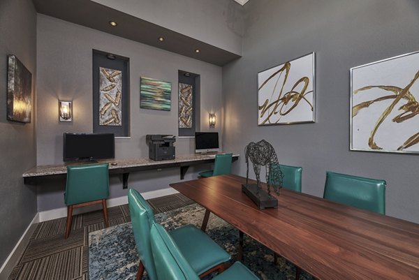 Modern business center with sleek workstations at Roots at Waco Apartments, ideal for professionals seeking luxury living in Waco