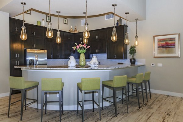 Clubhouse featuring modern design and comfortable seating at Roots at Waco Apartments