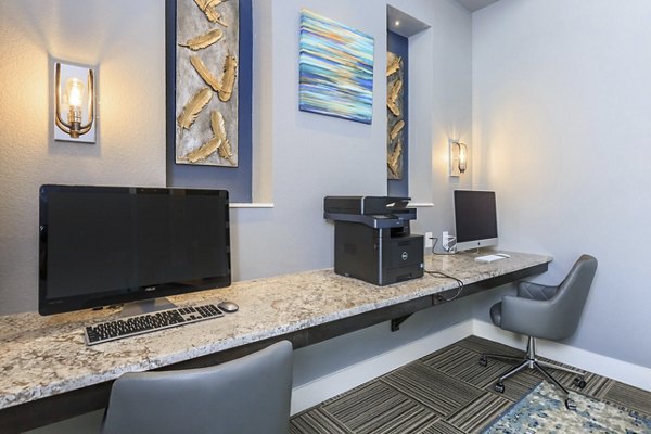 Business center with modern workstations at Roots at Waco Apartments