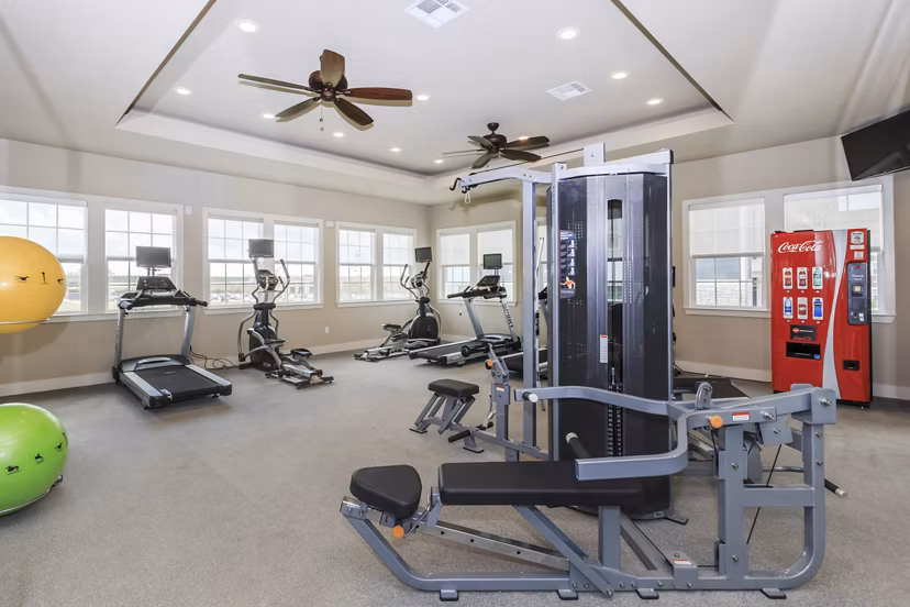 Modern fitness center with state-of-the-art equipment at Roots at Waco Apartments