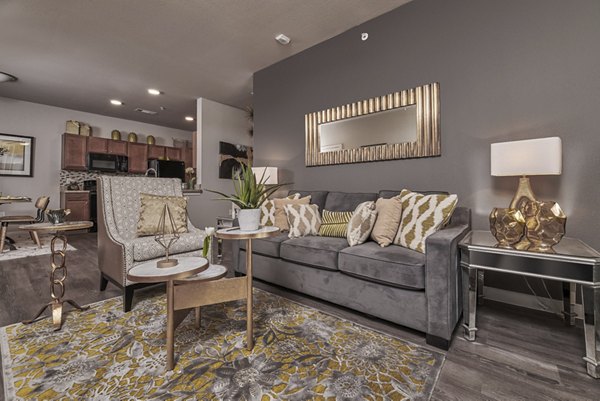 Living room featuring modern furniture and ample natural light at Roots at Waco Apartments, luxury residences in Waco