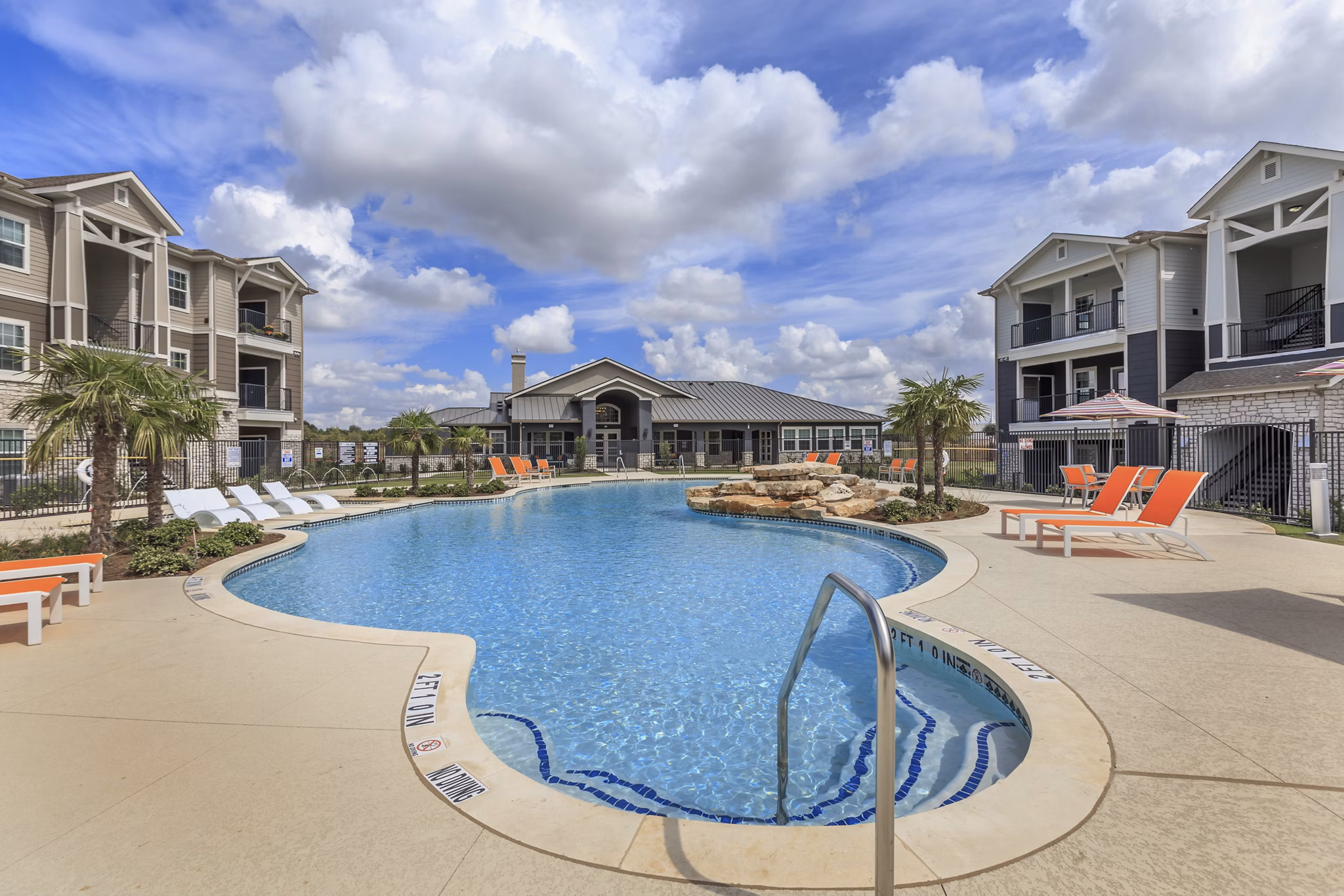 Resort-style pool with loungers at Roots at Waco Apartments, ideal for relaxation and recreation