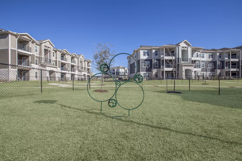 Spacious dog park at Roots at Waco Apartments, perfect for pet-friendly living